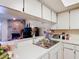 Kitchen area with a view to the Gathering room at 1806 Foxhall Cir # 1806, Kissimmee, FL 34741