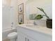 Clean bathroom featuring a shower-tub combo, white cabinets, framed artwork, and a neutral color palette at 2080 Ashwood Bluff Dr, Ocoee, FL 34761