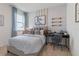 Stylish bedroom with sports theme, large window, plaid bedding, and dedicated desk space at 2080 Ashwood Bluff Dr, Ocoee, FL 34761