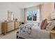 Bright bedroom features modern decor, a large window with outdoor views, and plush bedding for a cozy feel at 2080 Ashwood Bluff Dr, Ocoee, FL 34761