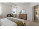 Bright bedroom featuring neutral tones, carpet floors, and a window with natural light at 2080 Ashwood Bluff Dr, Ocoee, FL 34761