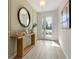 Inviting entryway with a wood table, mirror, decor and natural light at 2080 Ashwood Bluff Dr, Ocoee, FL 34761