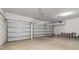 Spacious two-car garage with overhead door openers and ample space for storage at 2080 Ashwood Bluff Dr, Ocoee, FL 34761