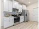Modern kitchen featuring stainless steel appliances, white cabinets, and subway tile backsplash at 2080 Ashwood Bluff Dr, Ocoee, FL 34761