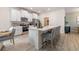 Contemporary white kitchen with stainless steel appliances, island with seating, and decor at 2080 Ashwood Bluff Dr, Ocoee, FL 34761