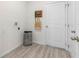 Functional laundry room with sleek floors and ample storage for laundry essentials at 2080 Ashwood Bluff Dr, Ocoee, FL 34761