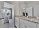 Bathroom featuring double sinks with granite countertop and an adjacent bedroom at 2092 Ashwood Bluff Dr, Ocoee, FL 34761
