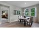 Elegant dining room featuring a marble table, neutral chairs, natural light, and tile floors for a modern look at 2092 Ashwood Bluff Dr, Ocoee, FL 34761