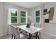 Bright dining area with a marble table, modern chairs, and abundant natural light from the surrounding windows at 2092 Ashwood Bluff Dr, Ocoee, FL 34761