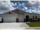Charming single-story home featuring a 2-car garage, manicured lawn, and welcoming entrance at 2092 Ashwood Bluff Dr, Ocoee, FL 34761