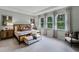 Serene main bedroom with plush carpet, natural light, and tray ceiling at 2092 Ashwood Bluff Dr, Ocoee, FL 34761