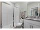 A bright bathroom features a glass-enclosed shower, toilet, vanity with granite, and modern fixtures at 2117 Greenwood Oak Dr, Ocoee, FL 34761
