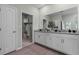 Bathroom featuring a double sink vanity with granite countertops, and a large closet with shelving at 2117 Greenwood Oak Dr, Ocoee, FL 34761