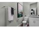 A well-lit bathroom features a toilet, vanity with granite countertop, mirror, and decor at 2117 Greenwood Oak Dr, Ocoee, FL 34761