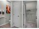 Bathroom showcasing a water closet, closet with shelving, and wood-look tile flooring at 2117 Greenwood Oak Dr, Ocoee, FL 34761