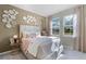 A light-filled bedroom features a comfortable bed, side table, decorative mirrors, and neighborhood views at 2117 Greenwood Oak Dr, Ocoee, FL 34761