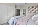 This cozy bedroom has a comfortable bed, closet, and ensuite bathroom entrance at 2117 Greenwood Oak Dr, Ocoee, FL 34761