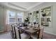 Dining room with tray ceiling, modern light fixtures, and a view to the outside at 2117 Greenwood Oak Dr, Ocoee, FL 34761