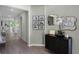 Inviting entryway with wood-look floors, stylish cabinet, and artful decor enhances the home's sophisticated charm at 2117 Greenwood Oak Dr, Ocoee, FL 34761