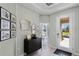A welcoming entryway has stylish decor, a statement mirror, and a peek into the bedroom at 2117 Greenwood Oak Dr, Ocoee, FL 34761