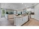 Open-concept kitchen and living area features a spacious island, stainless appliances, and abundant natural light at 2117 Greenwood Oak Dr, Ocoee, FL 34761