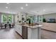 Bright, open kitchen with granite countertops, stainless steel dishwasher, and access to the living spaces at 2117 Greenwood Oak Dr, Ocoee, FL 34761