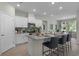 Modern kitchen features granite countertops, a spacious island with seating, and stainless steel appliances at 2117 Greenwood Oak Dr, Ocoee, FL 34761