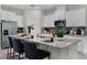 Open kitchen boasts a large granite island, stainless steel appliances, and white cabinets at 2117 Greenwood Oak Dr, Ocoee, FL 34761