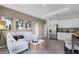 Inviting living room seamlessly connects to the kitchen with stainless steel appliances and modern cabinetry at 2117 Greenwood Oak Dr, Ocoee, FL 34761
