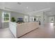 Airy living room featuring a large sofa, wood-look tile floors and views to dining area at 2117 Greenwood Oak Dr, Ocoee, FL 34761