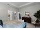 Calm primary bedroom features a neutral color palette, ensuite bathroom access, and walk-in closet at 2117 Greenwood Oak Dr, Ocoee, FL 34761