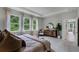 Bright main bedroom boasts soft carpet, a tray ceiling, a decorative accent wall, and large, sunlit windows at 2117 Greenwood Oak Dr, Ocoee, FL 34761
