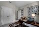 This home office features a unique desk, gallery wall, neutral carpet, and modern lighting at 2117 Greenwood Oak Dr, Ocoee, FL 34761