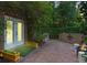 Enchanting brick patio features lush landscaping, planter boxes, string lights, and fire pit area at 2238 Hawick Ln # 2238, Winter Park, FL 32792
