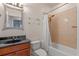 Bathroom with dark granite countertop, neutral tile, and a shower and tub combination at 2238 Hawick Ln # 2238, Winter Park, FL 32792