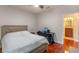 This bedroom features wood floors, a light-colored wall and a modern black desk and chair at 2238 Hawick Ln # 2238, Winter Park, FL 32792