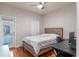 Cozy bedroom featuring wood floors, neutral walls, a comfortable bed and a view to the balcony at 2238 Hawick Ln # 2238, Winter Park, FL 32792