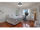 Bright bedroom featuring wood floors, a large window, and a comfortable bed at 2238 Hawick Ln # 2238, Winter Park, FL 32792