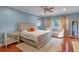 Serene bedroom with soft blue walls, wooden floors, and natural light from the window at 2238 Hawick Ln # 2238, Winter Park, FL 32792