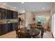Cozy dining area with a built-in wine rack, dark wood table, and a view of the kitchen, creating an inviting space at 2238 Hawick Ln # 2238, Winter Park, FL 32792