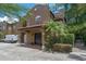 Charming two-story home featuring a covered entryway, red tile roof, and lush tropical landscaping in a well-maintained community at 2238 Hawick Ln # 2238, Winter Park, FL 32792