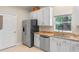 Bright kitchen featuring white cabinets, stainless steel appliances, granite countertops, and tile floors, creating a modern space at 2238 Hawick Ln # 2238, Winter Park, FL 32792