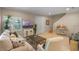 Inviting living room featuring neutral decor, tile flooring, large windows, and a staircase leading to the upper level at 2238 Hawick Ln # 2238, Winter Park, FL 32792