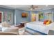 Bright main bedroom with a seating area, hardwood floors, and access to a balcony at 2238 Hawick Ln # 2238, Winter Park, FL 32792