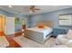 Bright main bedroom with a king bed, hardwood floors, and two bedside tables at 2238 Hawick Ln # 2238, Winter Park, FL 32792