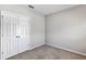 Carpeted bedroom featuring a closet, base molding, and neutral paint at 2426 Addison Creek Dr, Kissimmee, FL 34758