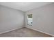 Neutral carpeted bedroom featuring a window, base molding, and neutral paint at 2426 Addison Creek Dr, Kissimmee, FL 34758