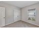 Carpeted bedroom featuring a window, base molding, and closet at 2426 Addison Creek Dr, Kissimmee, FL 34758