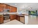 Modern kitchen with granite countertops, stainless steel appliances, and wooden cabinetry at 2426 Addison Creek Dr, Kissimmee, FL 34758