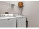 Laundry room featuring a washer, dryer, and wire shelf at 2426 Addison Creek Dr, Kissimmee, FL 34758